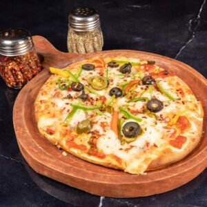 Close-up of a freshly baked pizza with toppings on a wooden tray, accompanied by spice jars.